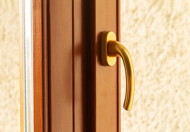 Golden metal window or door handle closeup