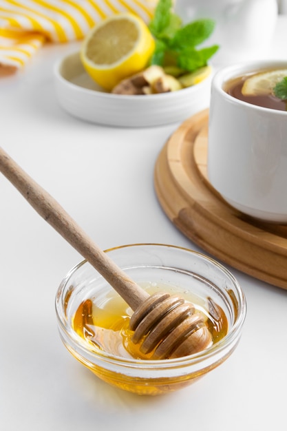 Golden natural honey autumn winter hot drink ingredient glass bowl honey spoon seasonal