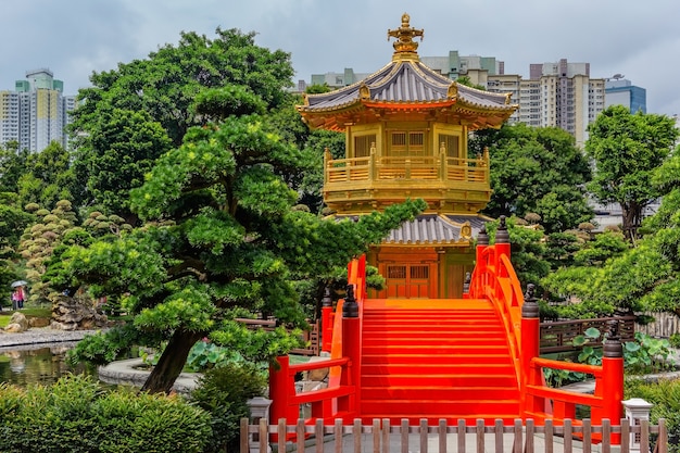 Golden pagoda of Nan Lian garden in Hong Kong city with a cloudy sky, Hongkong China