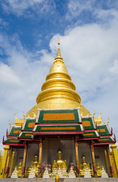 golden pagoda with buddha statues  at lamphun thailand