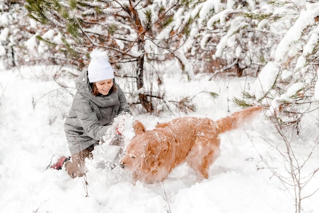 Golden retriever dog with girl in winter time