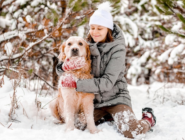 Golden retriever dog with girl in winter time