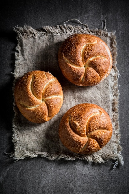 Golden rolls on rustic grey linen napkin