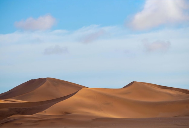 Golden sand dune 7 and white clouds on a sunny day in the Namib desert Fantastic place for travelers and photographers