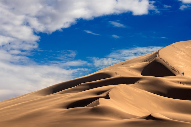 Golden sand dune 7 and white clouds on a sunny day