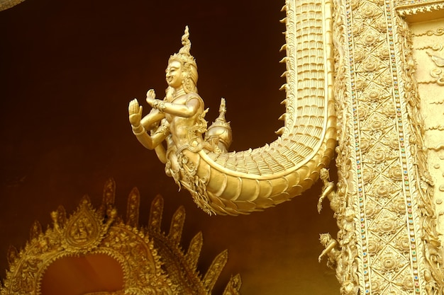 Golden sculpture of Naga on the gate at Wat Sri Panthon temple.