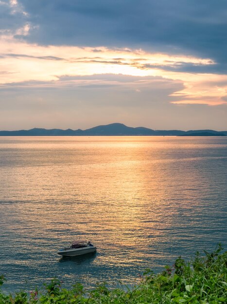 Golden sea with boat and island