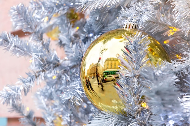 Golden shiny ball on christmas decorated street in paris france