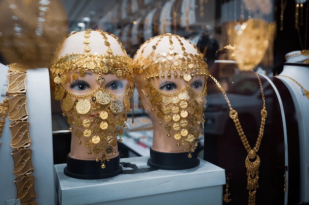 Golden shop window display traditional arabic face mask jewelry old town of Jeddah Saudi Arabia