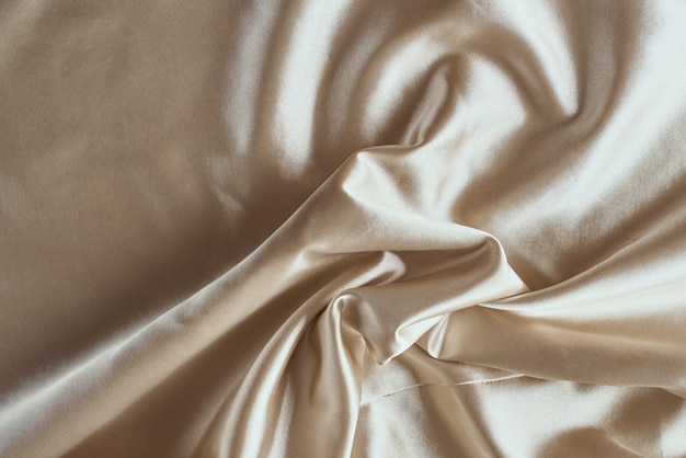 Golden silk with folds.  Abstract texture of rippled satin surface