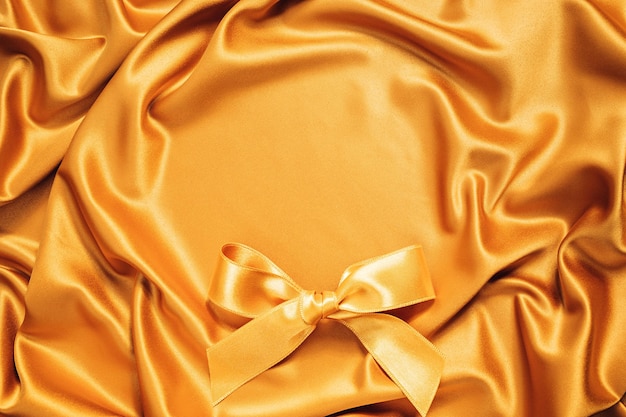 Golden silky fabric round copy space texture background