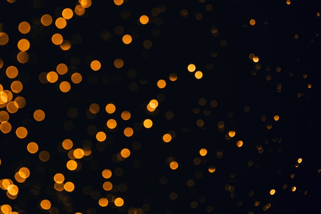 Golden sparkles festive background bokeh lights with bright shiny effect