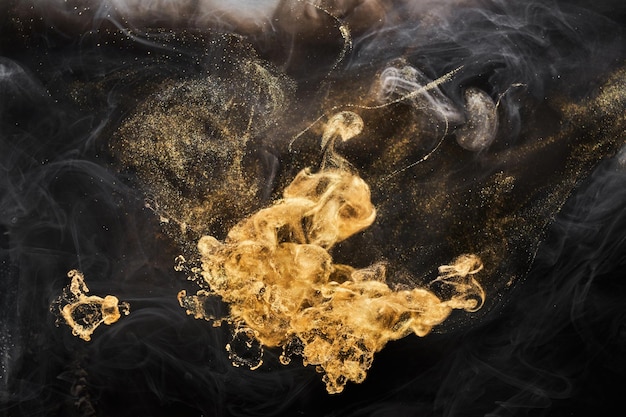 Golden sparkling abstract background luxury black smoke acrylic paint underwater explosion cosmic swirling ink