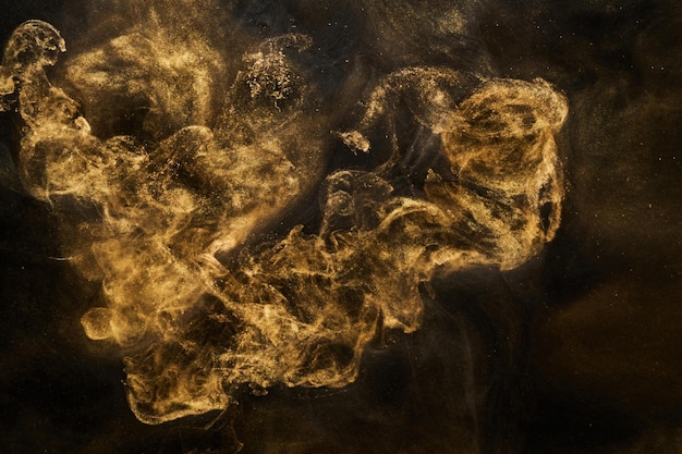 Golden sparkling abstract background luxury black smoke acrylic paint underwater explosion cosmic swirling ink