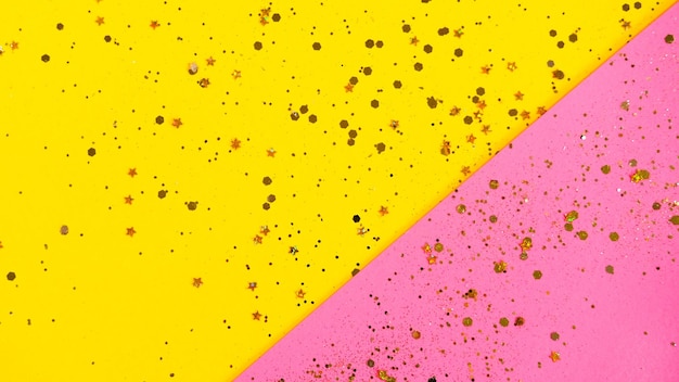 Golden star sprinkles on yellow and pink background