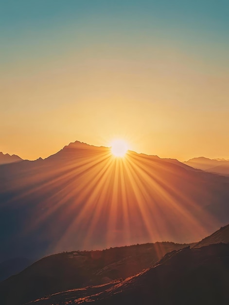 Golden sun setting behind distant mountain peaks