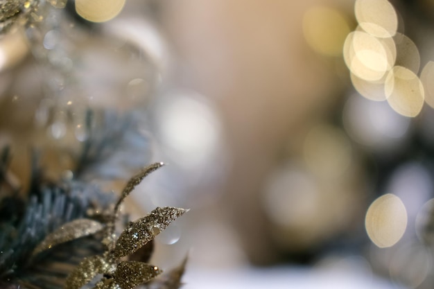 Golden toys on the Christmas tree. Bokeh. Background. Calm colors, close-up.