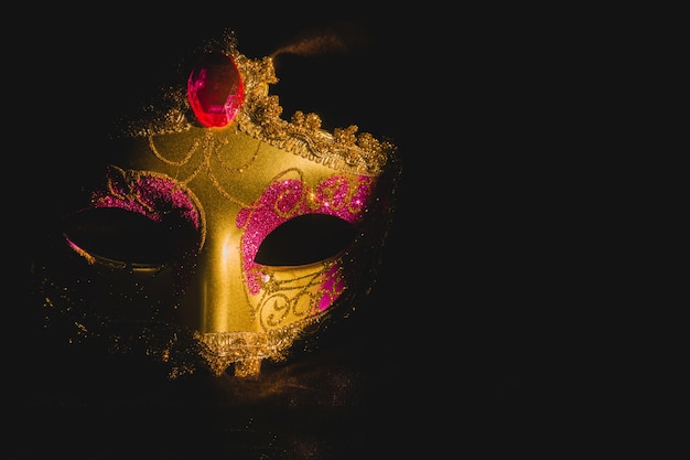 Golden venetian mask on a black background