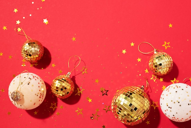 golden and white christmas balls with shiny stars on red background