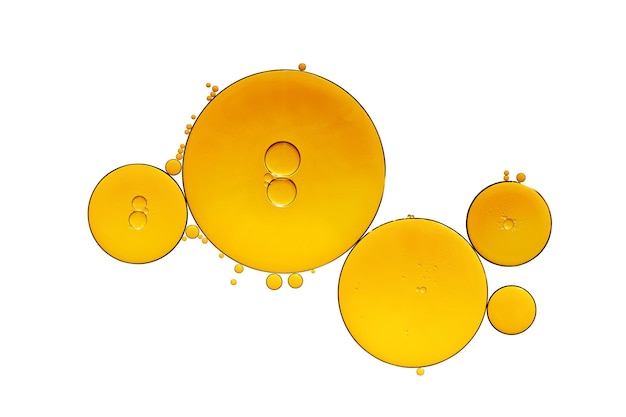 Golden yellow abstract oil bubbles or face serum isolated on white background