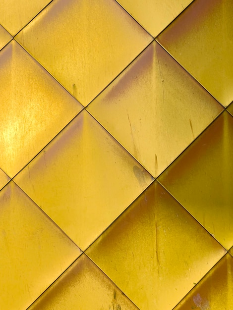 Golden yellow brass tiles wall background