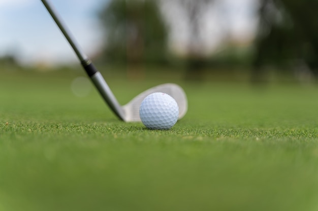 Golf ball and golf club on a golf course