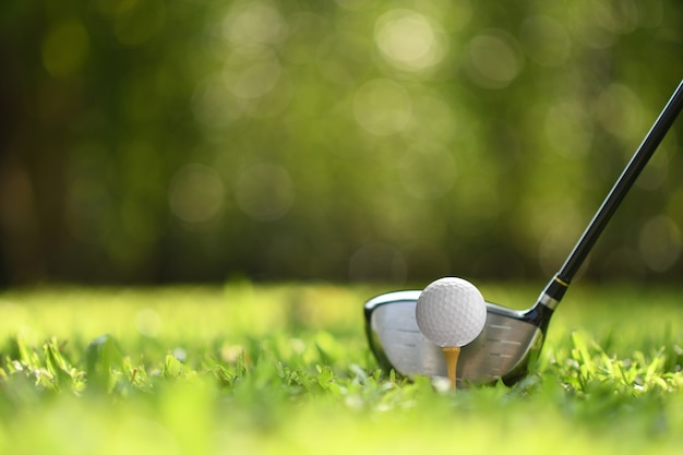 Golf ball on green grass ready to be struck on golf course