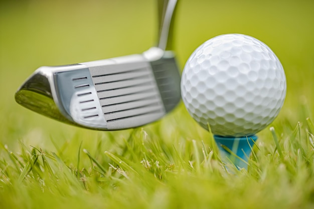 Golf ball on tee in front of driver