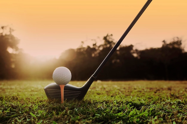 Golf clubs and golf balls on a green lawn in a beautiful golf course