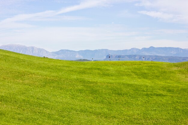 Golf course in Belek. Green grass on the field. Blue sky, sunny 