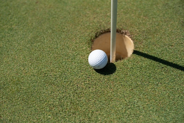 Golf field with white ball near the hole