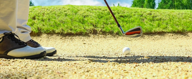 Golf shot from sand bunker golfer hitting ball from hazard