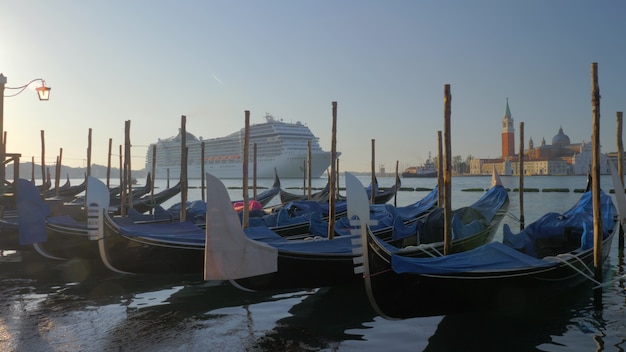 Gondola boats and a cruise ship in venice italy