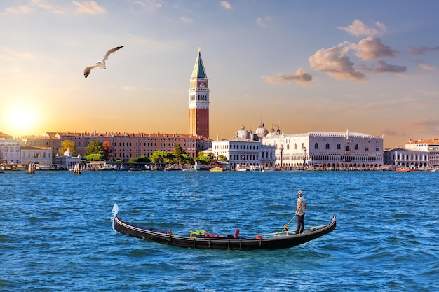 Gondola in the lagoon and the main view of Venice Italy