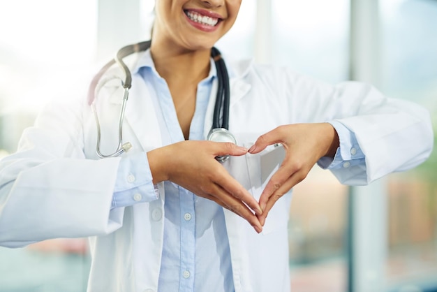 Good health is a longterm investment Portrait of a young female doctor making a heart shape with her hands