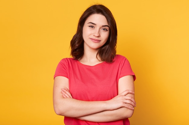 Good looking adorable young woman looking directly at camera