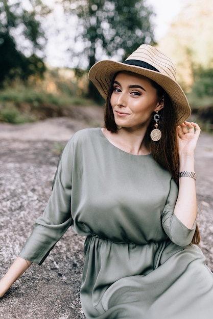 Good-looking brunette woman in hat and on hat having magic sincere smile being happy to recieve proposal from her boyfriend. Positive emotions and beauty concept