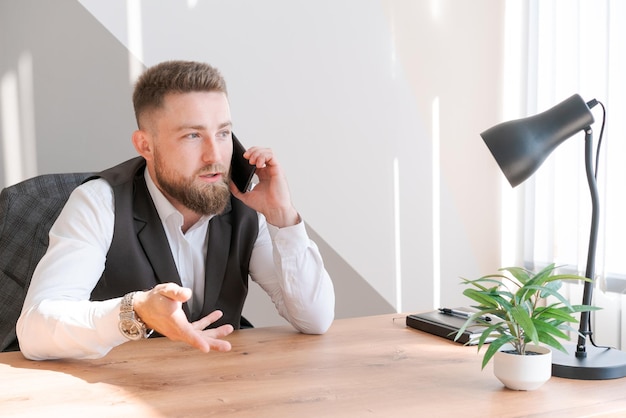 Good news Happy caucasian businessman in shirt talking on phone with client