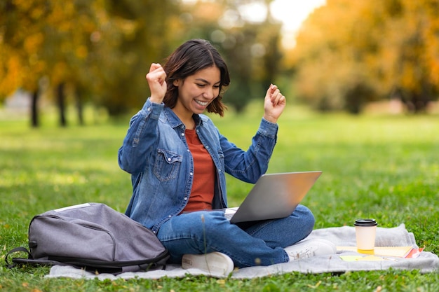 Good News Joyful Arab Female Student Celebrating Success With Laptop Outdoors