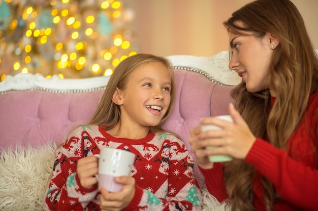 Good talks. Mom and daughter sitting on the sofa and talking