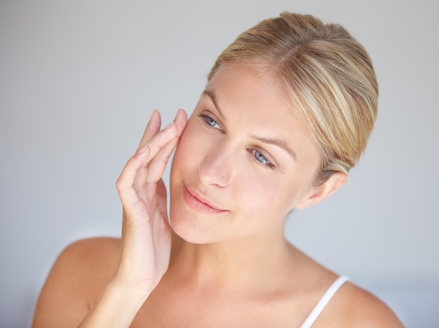 Goodbye wrinkles hello flawless skin Cropped shot of a beautiful woman touching her face