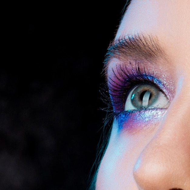 Gorgeous brunette with bright shining makeup blue eye shadow closeup face blue eyes bright makeup