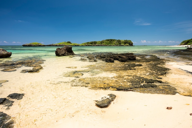 Gorgeous crystalline sea coastal rocks white sands islets at Hoshizuna beach Iriomote island