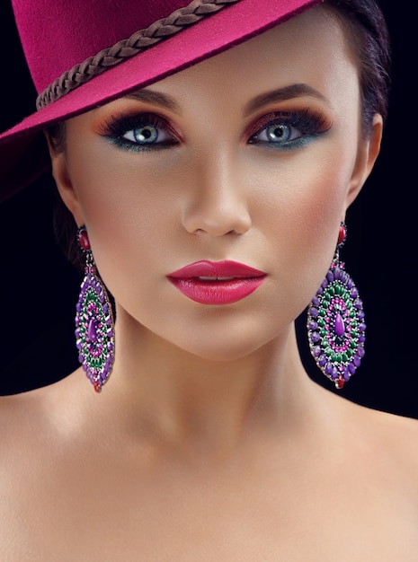 Gorgeous elegant woman in a hat posing in studio