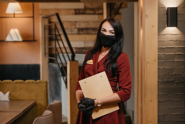 Gorgeous female restaurant manager in black disposable gloves