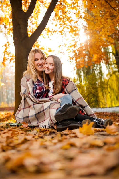 Gorgeous mother hugging her cheerful daughter