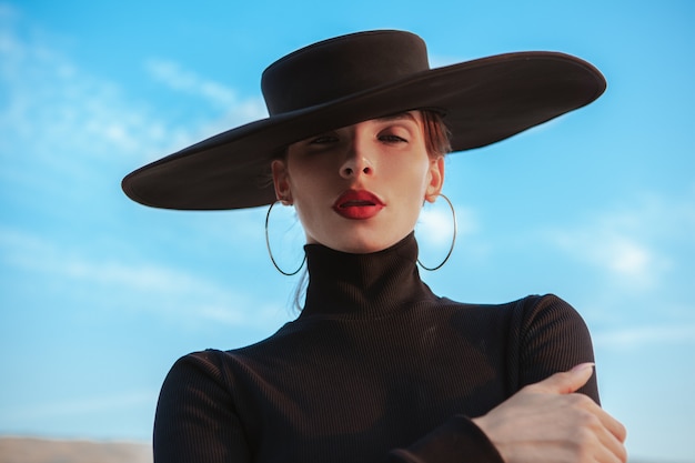 Gorgeous sexy woman dancing on the sand in the desert