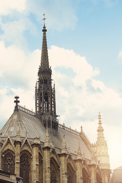 Gorgeous sunny day over Notre Dame cathedral with puffy clouds Paris France