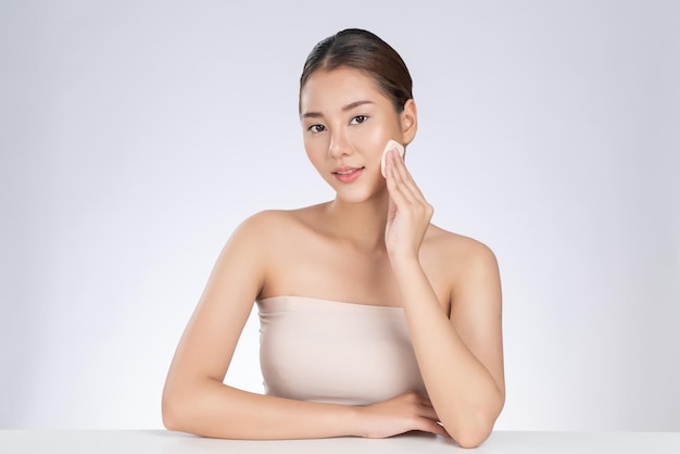 Gorgeous woman applying her cheek with dry powder