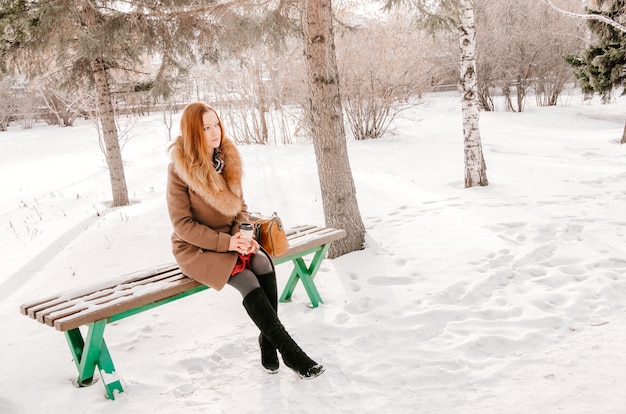 Gorgeous woman in the park during winter